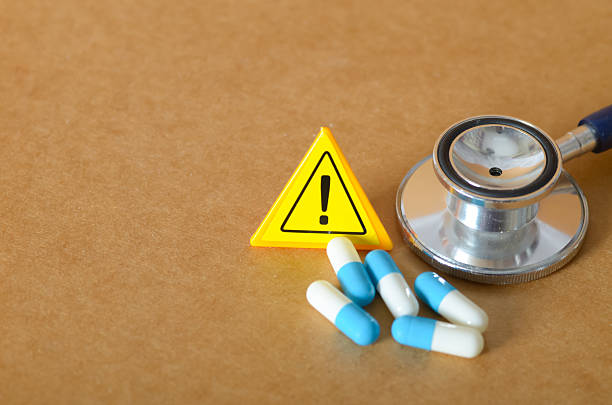 istock Medical Warning: Health Risk Concept with Stethoscope, Pills, and Caution Sign. 2233108381