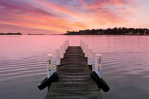 istock Empty pier on a calm lake at sunrise 2233111650