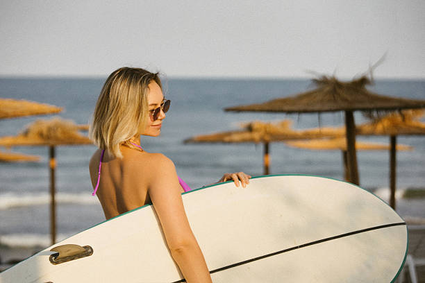 istock Attractive young woman in sunglasses and bikini 2233112984