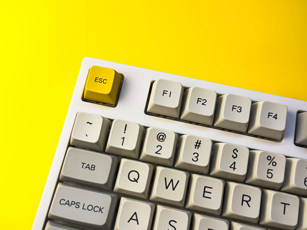 istock White mechanical keyboard with bright Esc key on bright yellow background, minimalism, keyboard buttons. A keyboard with a yellow key on the bottom left 2233113463