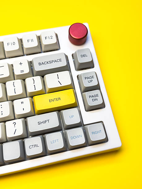 istock White mechanical keyboard with bright Enter key on bright yellow background, minimalism, keyboard buttons. A keyboard with a yellow key on the bottom left 2233113527