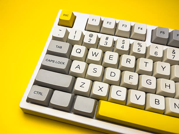 istock White mechanical keyboard with bright Esc key on bright yellow background, minimalism, keyboard buttons. A keyboard with a yellow key on the bottom left 2233114403