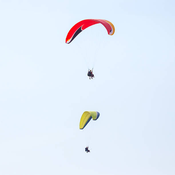 istock Paragliders soaring high above a scenic landscape during bright daylight 2233114774