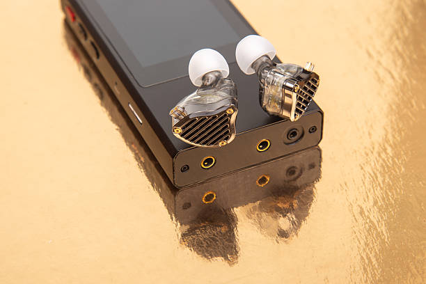 istock High-quality audio gear showcasing custom earphones on reflective gold surface 2233115000
