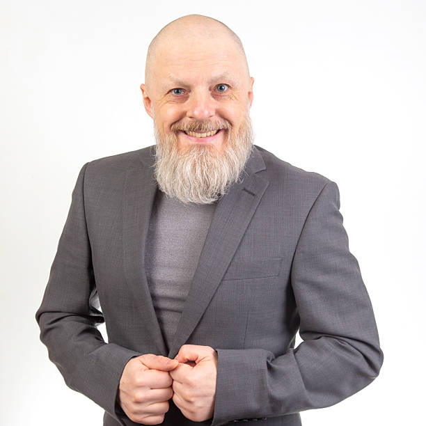 istock Professional man with a beard wearing a suit smiling confidently against a plain backdrop 2233117620