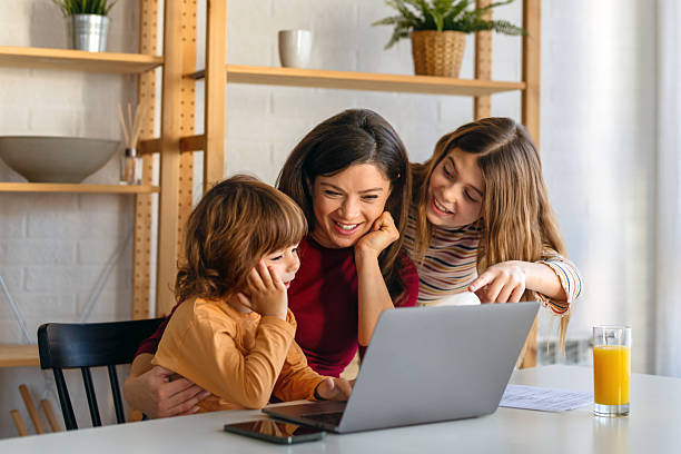 istock Happy single parent with cute excited small kids son using laptop computer at home. Technology 2233120639