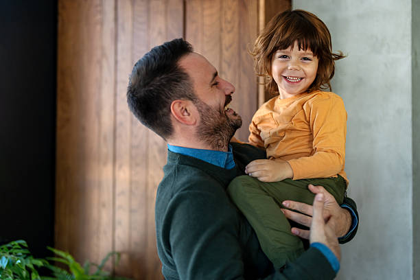 istock Affectionate single dad enjoy chatting with little son tell about passed day, having fun together 2233121082
