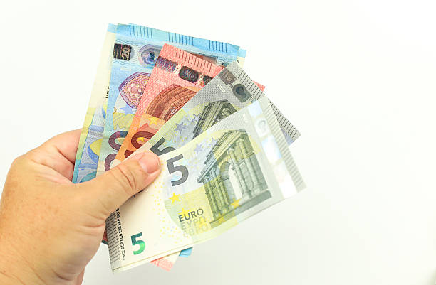 istock Hand holding Euro bills on white background 2233121666