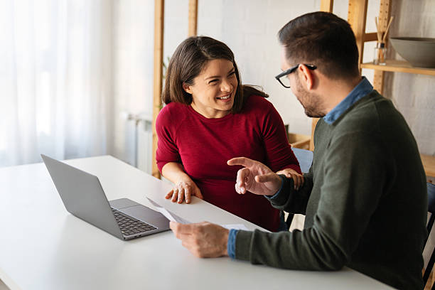 istock Happy businesspeople laughing while collaborating on a new project in an office. 2233121815