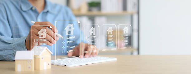 istock Businessman using digital tablet with virtual property documents and checklist icons. Concept of real estate technology, online mortgage, smart contract, and house investment. 2233121935