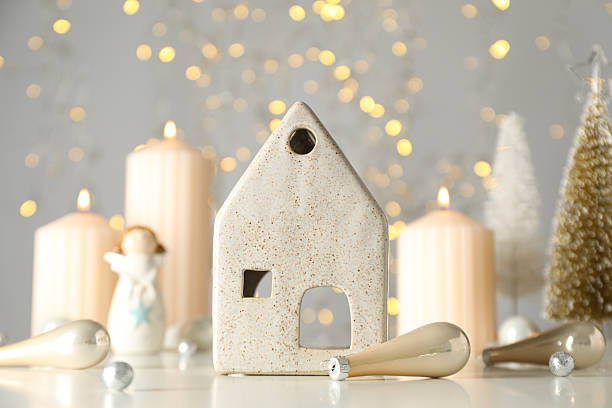 istock Candles, ceramic house and New Year's balls on light background 2233122332