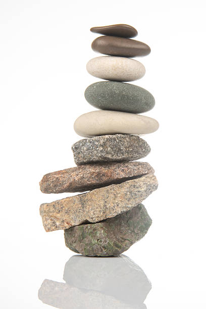istock Balanced stone tower showcasing natural textures in serene indoor setting 2233122903