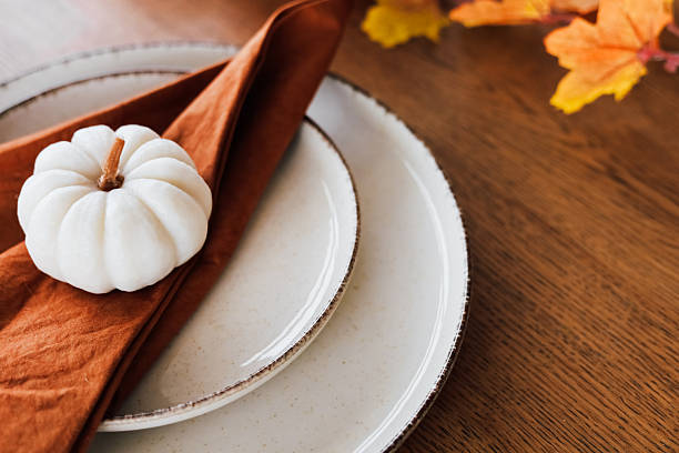 istock Elegant fall table setting with decorative pumpkin and autumn leaves on wooden surface 2233122926