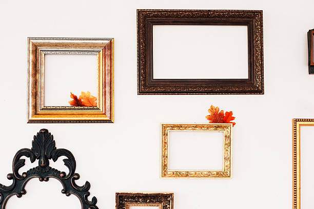 istock Decorative wall with empty frames and autumn leaves in a cozy indoor setting 2233122936