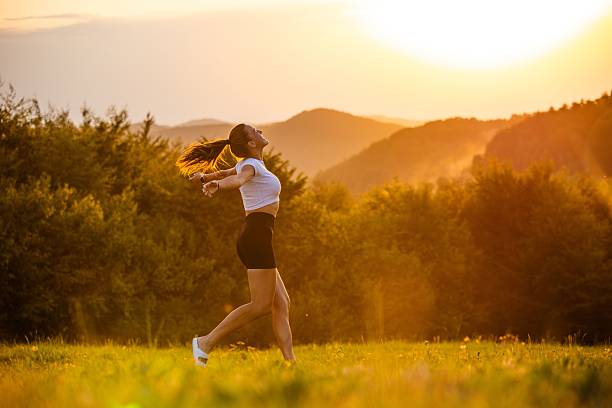 istock Woman enjoying sunset in nature 2233123244