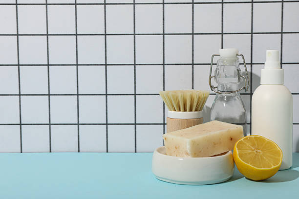 istock Soap, lemon, brush and bottles on table on light background, space for text 2233123551