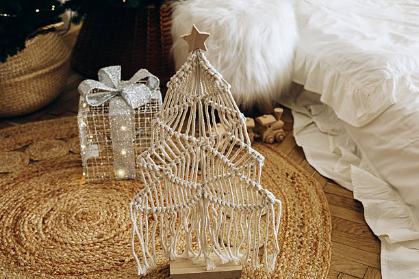 Festive macrame Christmas tree decor with a glittery gift in a cozy living room setting