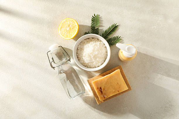 istock Natural cleaning products, bottles and branch on beige background, top view 2233123724