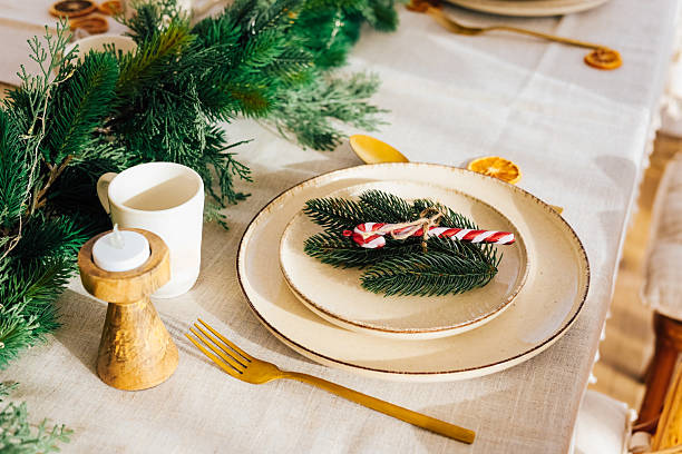 istock Elegant holiday dining table setup with festive decorations and winter greenery 2233124018