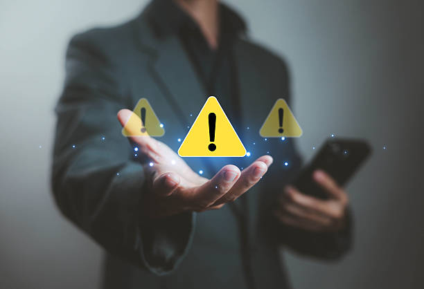 istock Businessman holding digital warning icons in hand, cybersecurity caution, data risk alert, system error prevention, internet safety, online threat protection technology concept. 2233132719