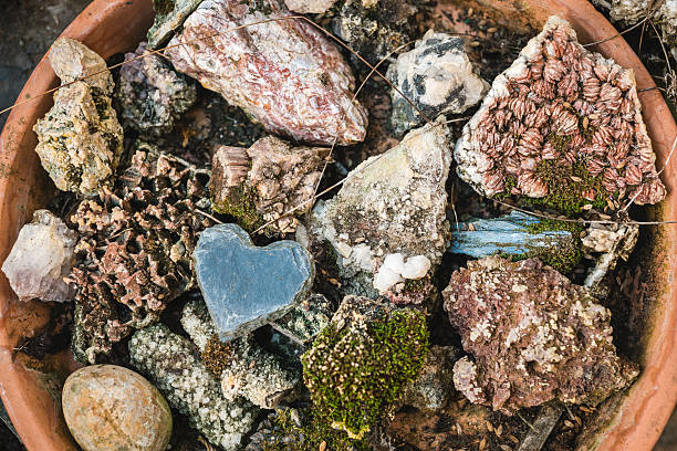 Stone heart on a rock with pebbles