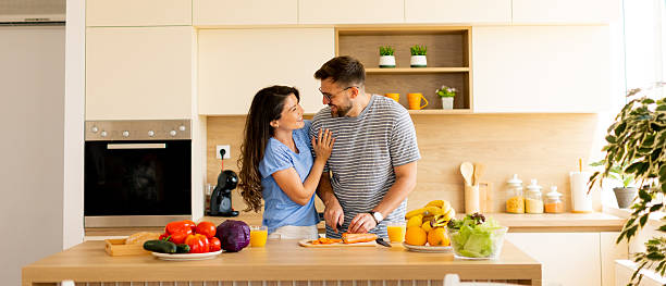 istock Couple enjoying a joyful cooking moment in a bright modern kitchen 2233134993