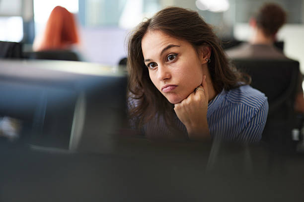 istock Worried female programmer working on desktop PC in the office. 2233135479