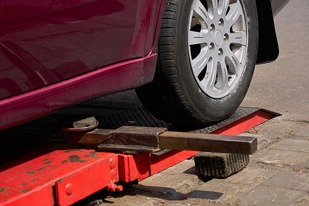 istock Red car on lift for changing wheel,auto repair 2233136389