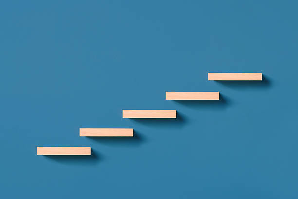 istock Wooden pegs forming a stairway 2233138385