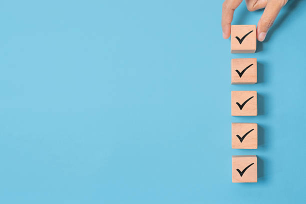istock Wood cube with check mark on blue background, Checklist concept, Copy space 2233138402