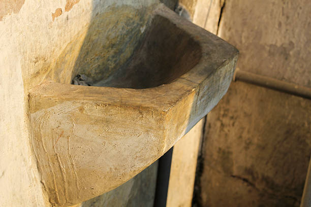istock Rustic concrete corner sink offers vintage charm, perfect for restoration or unique architectural design projects 2233139849