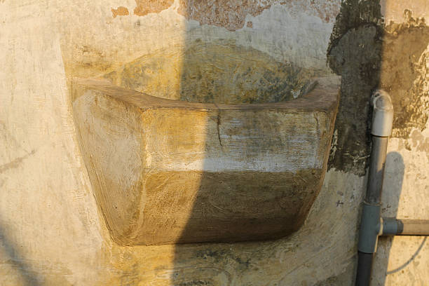 istock Rustic concrete corner sink offers vintage charm, perfect for restoration or unique architectural design projects 2233139852