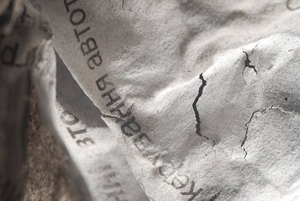 A burnt sheet of papper with text on it, close-up