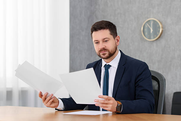 istock Banker working with documents at wooden table in office 2233145450