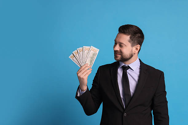 istock Banker with dollar banknotes on light blue background, space for text 2233145605