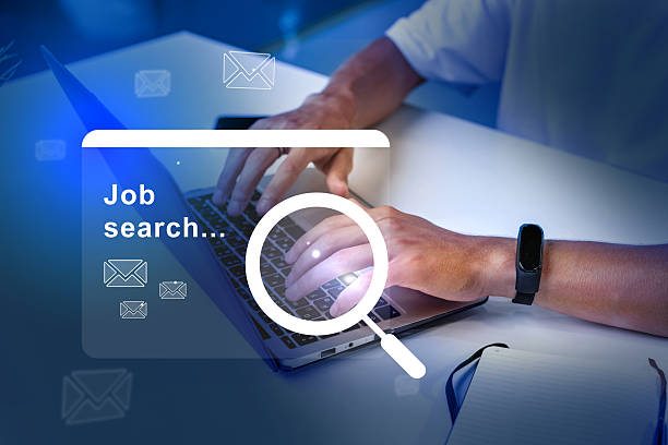 istock Hands typing on laptop during a job search in an organized workspace with blue lighting in the background 2233146623