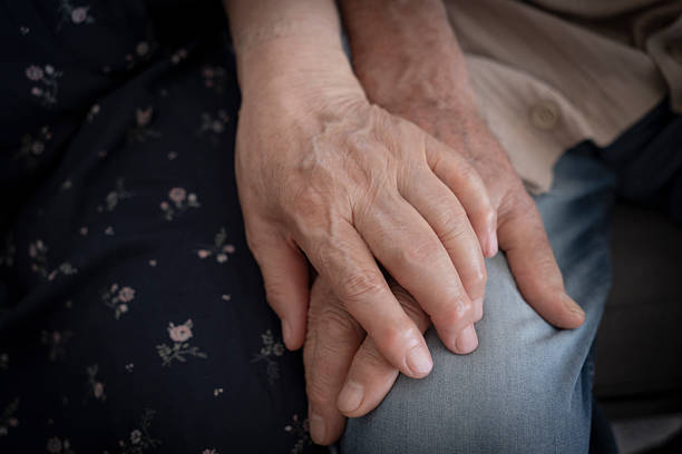 istock Senior man and woman holding hands 2233146734