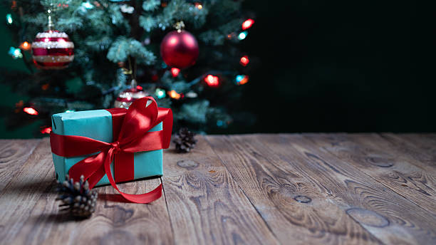 istock Festive Christmas Postcard Featuring a Present, Holiday Decorations, and a Wooden Surface 2233147828