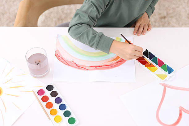 istock Little boy drawing at white table indoors, closeup 2233151423