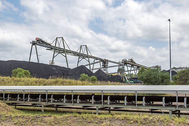 A dilapidated coal processing building surrounded by overgrown plants in eckley miners village on a spring day in weatherly pennsylvania.