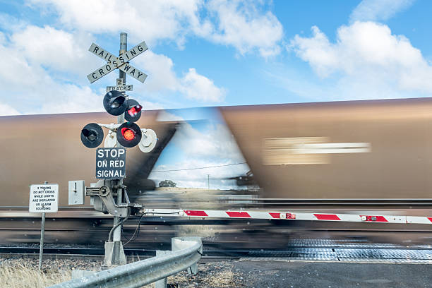 istock Coal train moving through road crossing. 2233152471