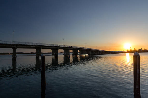 istock Forster Tuncurry Bridge spanning the lake at sunset, casting reflections on the water 2233153921