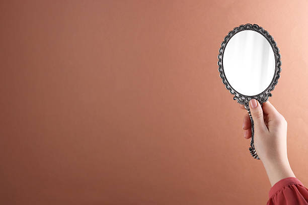 istock Woman holding beautiful mirror on beige background, closeup. Space for text 2233153972