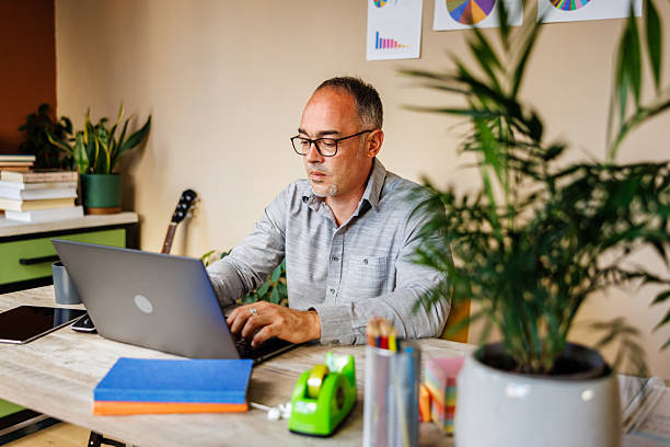 istock Focused Businessman Working on Laptop in Home Office 2233156998