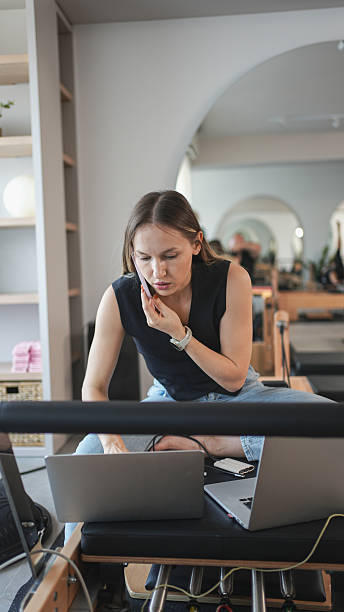 istock Professional Female Executive Juggling Phone Calls And Laptop Work While Staying Productive And Organized 2233157152