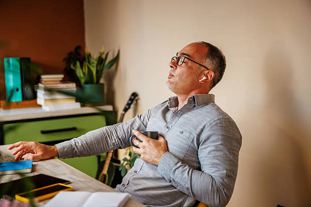 istock Man Enjoys Music in Office 2233157481
