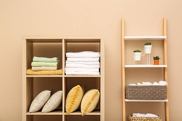 istock Folded towels and pillows on shelving unit indoors. Home textile storage 2233158456