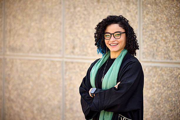 istock Contented businesswoman standing against wall 2233160915