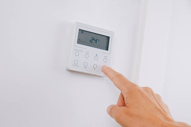 istock man switches the air conditioning on or off 2233161586