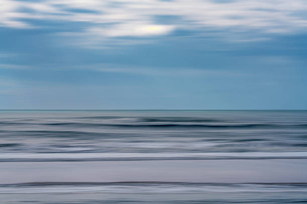 istock Abstract seascape with blurred waves and soft, streaked clouds in a tranquil palette. 2233162034
